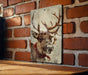 a picture of a deer on a brick wall