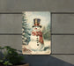 a picture of a snowman with a top hat and scarf