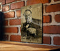 a picture of a man holding a gun on a brick wall