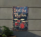 a sign on the side of a building that says beat the rhythm