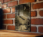 a picture hanging on a brick wall next to a wooden table