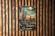 a sign on a wooden wall that says desert dreams