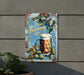 a metal sign with a mug of beer on it