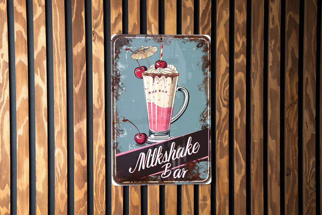 a metal sign on a wooden wall advertising milkshake bar
