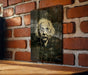 a picture of a man's face on a brick wall