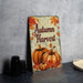 a metal sign that says autumn harvest on it