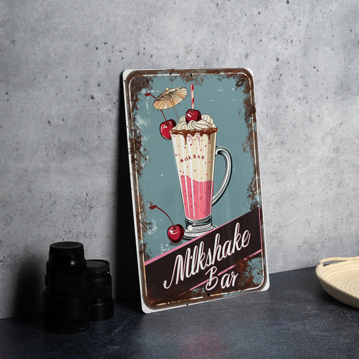 a metal sign that says milkshake bar on it