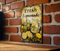 a sign on a brick wall that says fresh lemonade