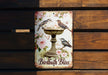 a birdbath bliss sign hanging on a wooden wall