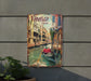 a metal sign with a picture of a gondola in venice
