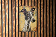 a painting of a dog on a wooden wall