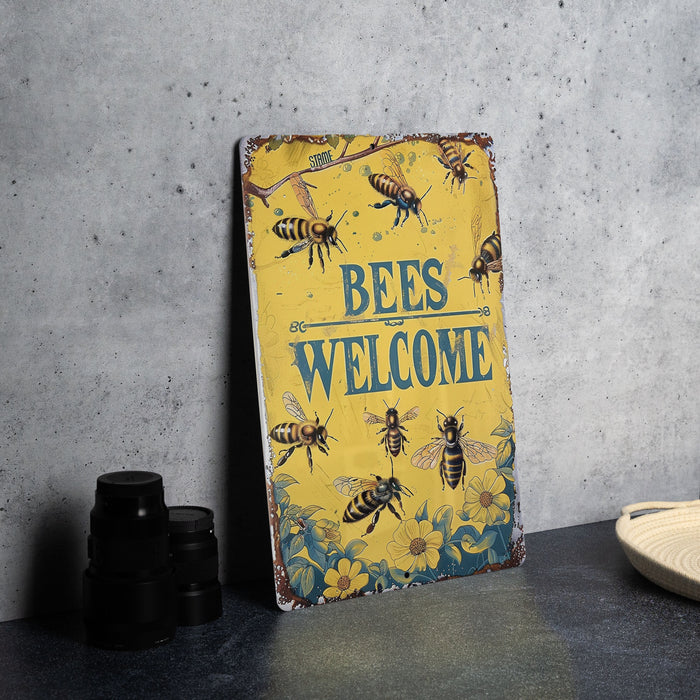 a sign that says bees welcome on a table