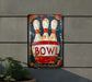 a bowling sign hanging on the side of a building