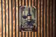 a sign on a wooden wall with a bottle of wine and a glass of wine