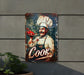 a sign with a chef holding a plate of food
