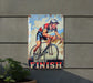 a metal sign with a picture of a man riding a bike