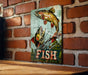 a picture of a fish on a brick wall