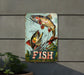 a fish sign hanging on the side of a building