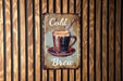 a sign on a wooden wall that says cold brew
