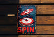 a sign on a wooden wall that says spin