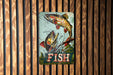 a fish sign hanging on a wooden wall