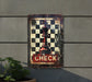 a metal sign with a chess piece on it
