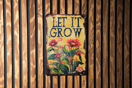 a sign on a wooden wall that says let it grow