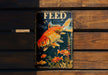 a metal sign with a gold fish on it