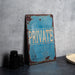 a blue private sign sitting on top of a table