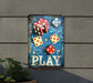 a metal sign that says play with dices on it