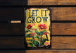 a sign that says let it grow on a wooden wall