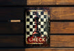 a metal sign with a chess piece on it