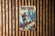 a poster of a man riding a bike on a wooden wall