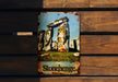 a sign on a wooden bench that says stonehenge