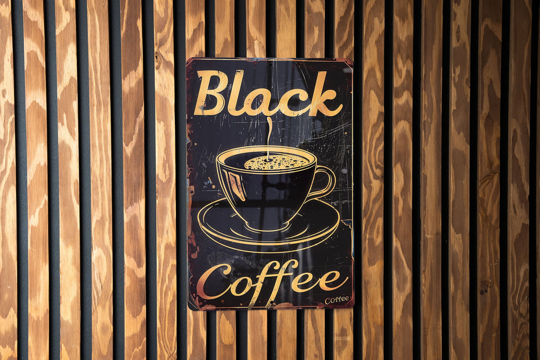 a black coffee sign on a wooden wall