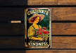 a tin sign with a woman holding a bunch of flowers