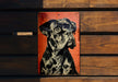 a picture of a black and white dog on a wooden wall