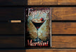a metal sign with a martini on it