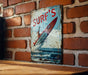 a picture of a surf board on a brick wall