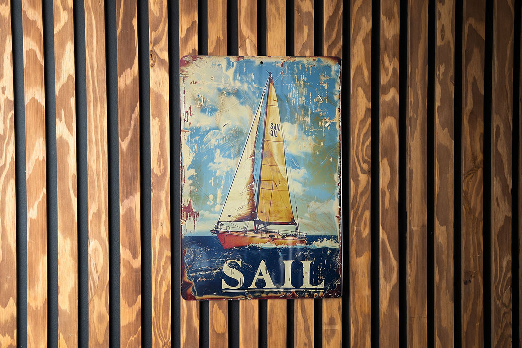 a sail sign hanging on a wooden wall