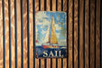 a sail sign hanging on a wooden wall