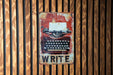 a sign with an old typewriter on it