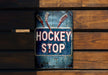 a hockey stop sign on a wooden bench