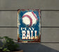 a metal sign with a baseball on it