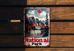 a national park sign hanging on a wooden wall
