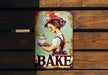 a tin sign that says bake on it