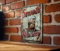 a sign on a brick wall that says smooth whiskey