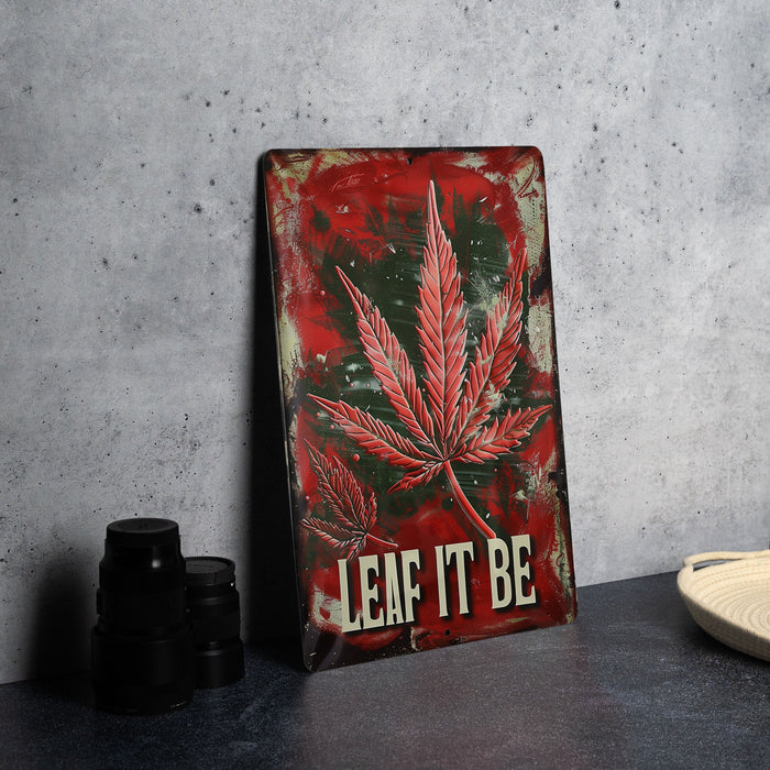 a metal sign with a marijuana leaf on it