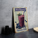 a blueberry smoothie sign sitting on a table