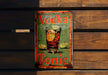 a metal sign that says vodka tonic on it